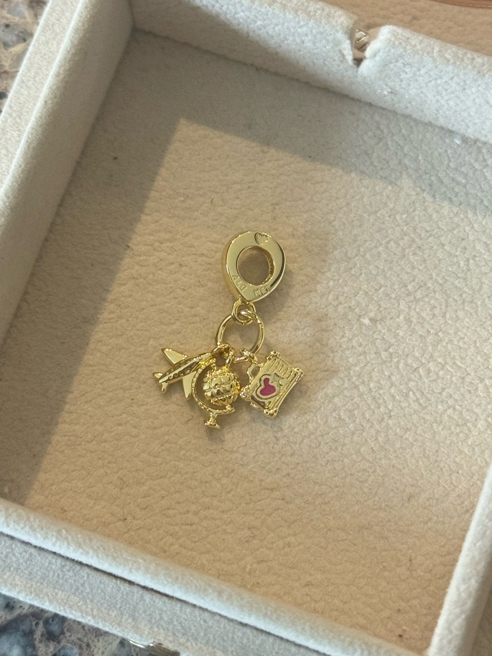 Pandora gold travel charm